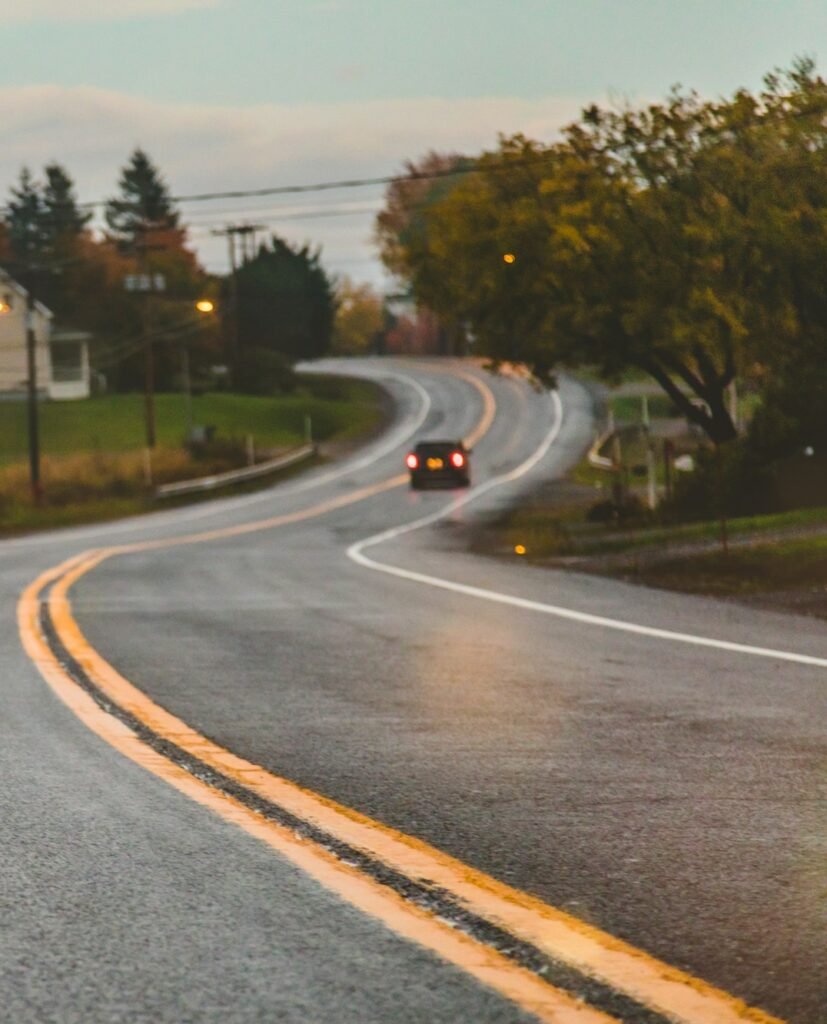 Car driving on road in evening